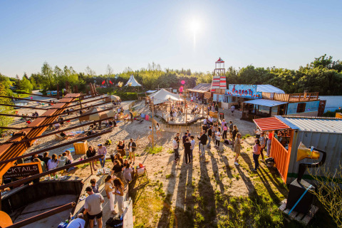 Visitors enjoy a sunny day at Netl Camping Kallumaan holiday park in Flevoland, Netherlands.