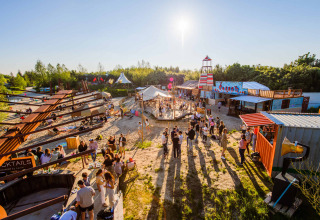 Visitors enjoy a sunny day at Netl Camping Kallumaan holiday park in Flevoland, Netherlands.