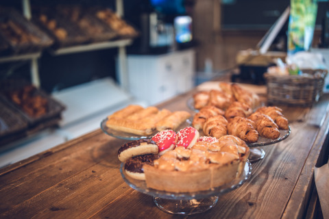 Pastries on a wooden counter at a bakery in Veluwepark de Bosgraaf holiday park, Gelderland, Netherlands.