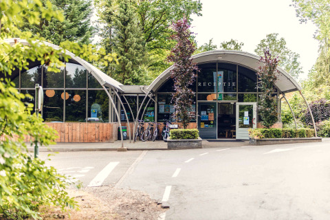 Entrée du parc de vacances Veluwepark de Bosgraaf à Gelderland, Pays-Bas, avec vélos et verdure.