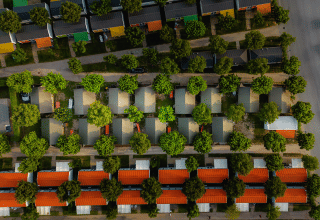 Aerial photo of colorful cabins and trees at Campeggio del Garda, a holiday park in Veneto, Italy.