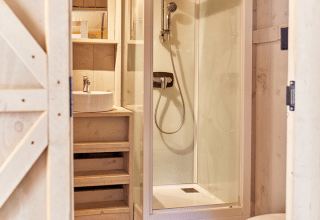 Bathroom inside the Villatent Outback safari tent at Campeggio del Garda, Italy, featuring shower and toilet.