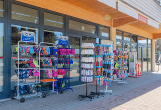 Shopfront at Campeggio Gasparina holiday park in Veneto, Italy, displaying sandals and holiday goods outside.