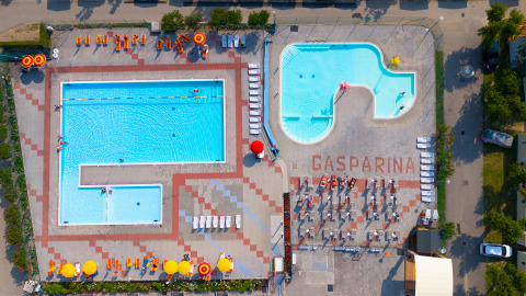 Vista aérea de piscinas y tumbonas en Campeggio Gasparina, un parque de vacaciones en Véneto, Italia.