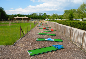 Mini golf course at Camping 't Geuldal, a holiday park surrounded by greenery in Limburg, Netherlands.