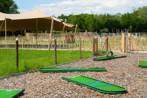 Parcours de mini-golf avec gazon vert et tente au Camping 't Geuldal, Limbourg, Pays-Bas, en été.