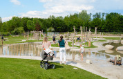 Families enjoy a sunny day at a playground in Camping 't Geuldal holiday park in Limburg, Netherlands.