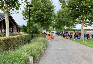 Gezinnen en kinderen komen samen aan het pad nabij de receptie van Camping Betuwe in Gelderland.