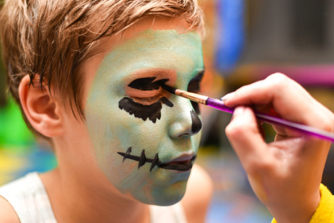 A child gets their face painted as a monster, a highlight activity at Camping Borken am See in Germany.
