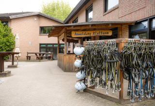 Climbing equipment and helmets at the registration area of Camping Borken am See in North Rhine-Westphalia, Germany.