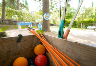 A bow, arrows, and targets at the archery range of Camping Colleverde, a holiday park in Tuscany, Italy.