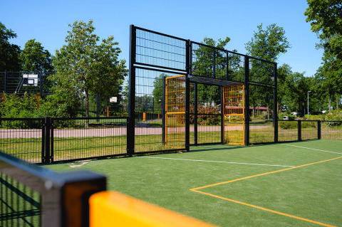 Outdoor sports field with a goal and basketball hoops at Camping de Schatberg holiday park in Limburg, Netherlands.