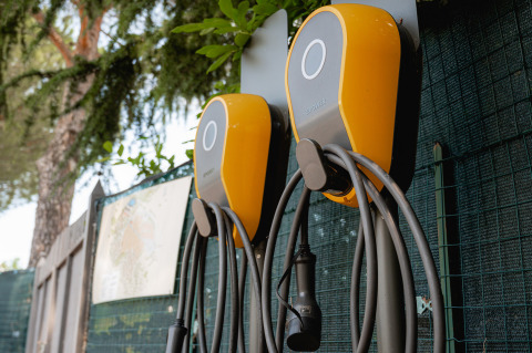 Two yellow EV charging stations at Camping Il Poggetto, a holiday park set in beautiful Tuscany, Italy.