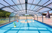 Covered children’s pool with play structures at Camping La Bretonnière holiday park in Pays de la Loire, France.