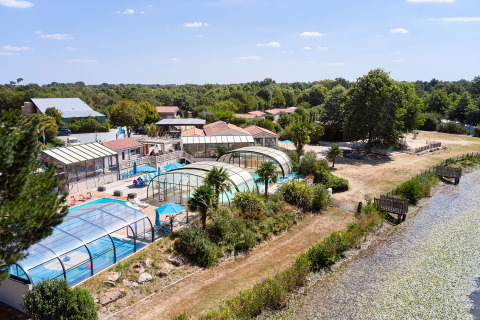Camping La Bretonnière holiday park in Pays de la Loire, France, featuring covered pools and lush greenery.