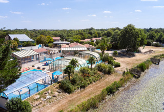 Camping La Bretonnière holiday park in Pays de la Loire, France, featuring covered pools and lush greenery.