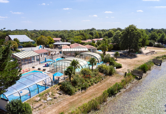 Camping La Bretonnière holiday park in Pays de la Loire, France, featuring covered pools and lush greenery.
