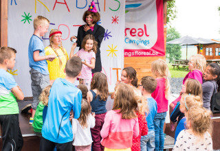 Kinderen beleven plezier aan een podiumshow op Camping La Colline, vakantiepark in Belgisch Luxemburg.