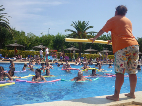 Aqua aerobics class taking place in the pool at Camping La Masia, Catalonia, Spain, with many participants.