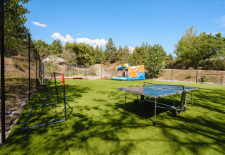 Sportplatz mit Tischtennisplatte, Fußballtoren und Hüpfburg im Camping La Presqu’île, Provence-Alpes-Côte d’Azur.