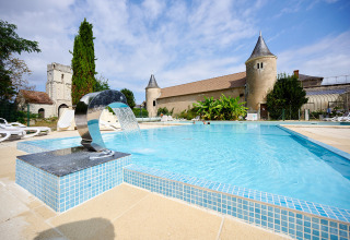 Außenpool mit modernem Brunnen im Ferienpark Camping Le Petit Trianon in Nouvelle-Aquitaine, Frankreich.