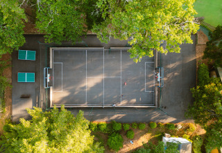 Aerial view of a multi-sports court with table tennis tables at Camping Le Sequoia, Nouvelle-Aquitaine, France.