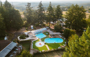 Aerial view of Camping Le Sequoia holiday park in Nouvelle-Aquitaine, France, featuring pools and trees.
