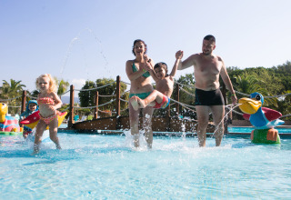 Famiglia che si diverte in piscina per bambini al Camping Leï Suves, villaggio vacanze in Provenza-Alpi-Costa Azzurra, Francia.
