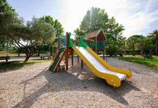 Bright playground with slide and climbing wall at Camping Les Pêcheurs in Provence-Alpes-Côte d’Azur, France.