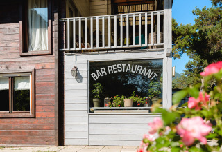 Fachada de Bar Restaurante en Camping River con flores, en la región de Provenza-Alpes-Costa Azul, Francia.