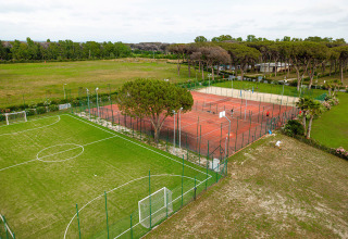 Vista aerea delle strutture sportive con campo da calcio e campi da tennis al Camping Roma Capitol, Lazio, Italia.