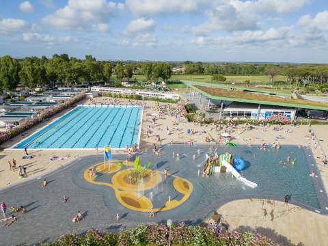 Aerial view of Camping Roma Capitol holiday park with pools, slides and sunbathers in Lazio, Italy.