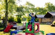 A child plays on colorful playground blocks at FarmCamps Five Star holiday park in Zeeland, Netherlands.