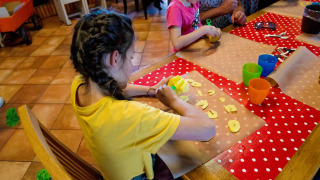 Niños cocinan en una actividad culinaria en FarmCamps Five Star, parque vacacional en Zelanda.