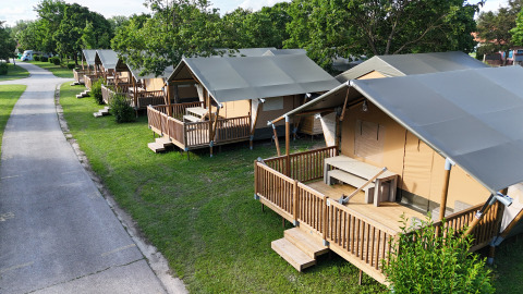 Row of modern glamping tents with wooden decks at Camping Terme Catez holiday park in Slovenia.
