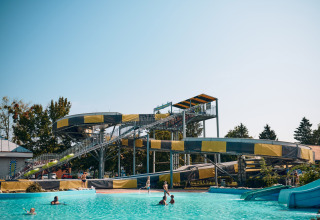 Water slide and swimming pool at Camping Terme Catez holiday park in Slovenia on a sunny day.