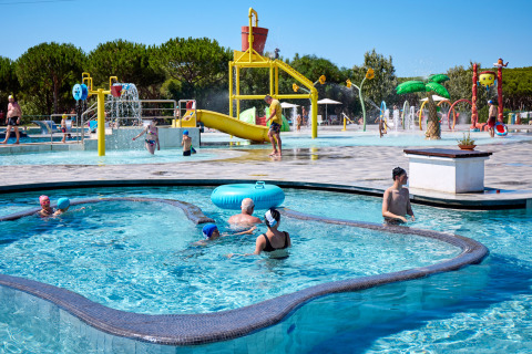 Children and families play in the water park at Camping Village Baia Blu La Tortuga, Sardinia, Italy.