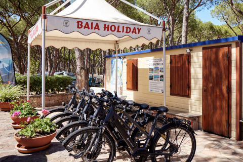 Bike rental stand at Camping Village Baia Blu La Tortuga holiday park in Sardinia, Italy, under tent.