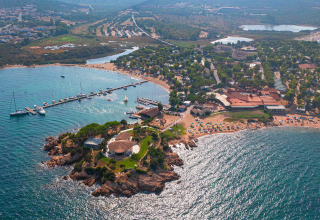 Aerial view of Centro Vacanze Isuledda holiday park in Sardinia, Italy, featuring beaches and marina.