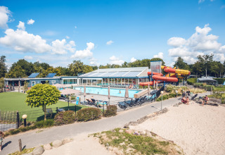 Blick auf den Swimmingpool und die Wasserrutschen im Holiday Park Ackersate, Gelderland, Niederlande bei Sonnenschein.