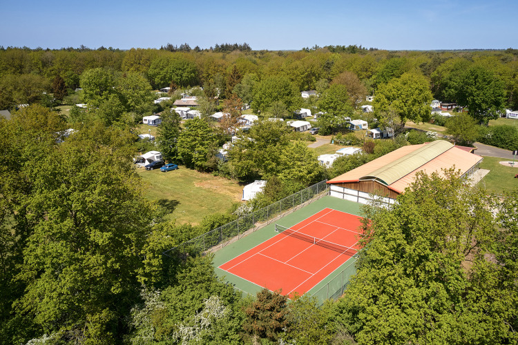 Luchtfoto van Holiday Resort de Bronzen Emmer in Drenthe, Nederland, met tennisbaan en kampeerplaatsen.
