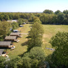 Aerial view of Holiday Resort de Bronzen Emmer in Drenthe, Netherlands, with tents and green fields.