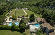 Aerial view of Medrose Camping holiday park in Auvergne-Rhône-Alpes, France, featuring pools and open fields.