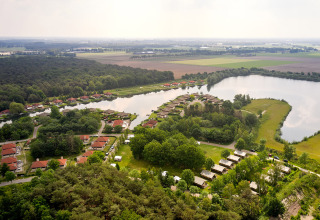 Aerial view of Parc de Witte Vennen holiday park, with cottages and a lake in Limburg, Netherlands.