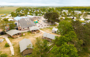 Aerial view of Vakantiepark De Nollen holiday park with tents, cabins, trees, and greenery in North Holland.