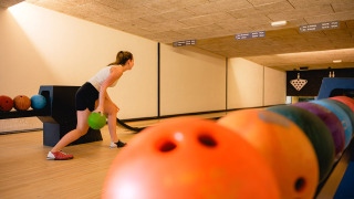 Femme jouant au bowling dans Vakantiepark de Twee Bruggen, parc de vacances aux Pays-Bas.