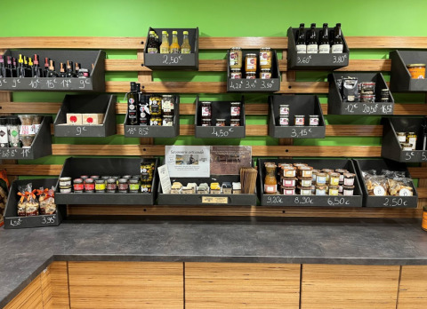 Shelves displaying local delicacies, snacks and drinks at Camping De l'Olivigne holiday park, Occitanie, France.