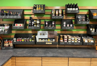 Shelves displaying local delicacies, snacks and drinks at Camping De l'Olivigne holiday park, Occitanie, France.
