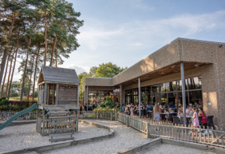 Familiepark Goolderheide: Zona de juegos al aire libre y terraza con visitantes en un parque en Limburg, Bélgica.