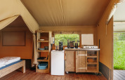 Interior of a safari tent with cozy kitchen setup at Familiepark de Vechtvallei, Netherlands.